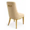 Krzesło beżowe złote nowoczesne designerskie z uchwytem do jadalni NAOMI podczas ekspozycji w showroomie Primavera Home, prezentujące wyjątkowy styl.