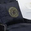 Decorative black velvet pillow with gold logo Medusa