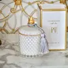 Decorative scented candle in a white and gold crystal glass container