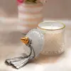 Decorative scented candle in a white and gold crystal glass container