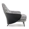 Modern, upholstered designer armchair on black legs with a LINEA footstool