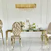 Designer dining table, glamor, with a glass top, steel, gold ELITE