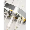 Kinkiet kryształowy srebrny Bulgari w jasnym wnętrzu. Lampa od Primavera Home.