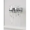 Kinkiet kryształowy srebrny Bulgari z detalami światła w tle. Lampa od Primavera Home.