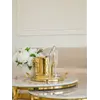Stolik kawowy okrągły glamour, złoty, biały marmur MARCO GOLD na tle innych mebli w salonie. Ekspozycja w salonie od Primavera Home.