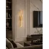 Kinkiet Kryształowy Złoty Podłużny Crystal w nocnym świetle, tworzący nastrojową atmosferę. Detal wykończenia od Primavera Home.