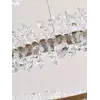 Żyrandol Kryształowy Nowoczesny Brina Złoty w strefie odpoczynku, tworzący przytulny klimat. Oświetlenie marki Primavera Home.