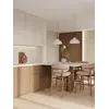 Designerski Hoker Drewniany Olivia – Krzesło Barowe w ciepłym świetle od Primavera Home.