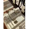 Widok nocny z designerskim narożnikiem modułowym boucle NICEA w nowoczesnym salonie. Oferowane przez Primavera Home.