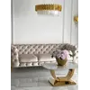 Luksusowa złota sofa pikowana DIVA GOLD w ekspozycji showroomu. Detal wykończenia pokazany przez Primavera Home.
