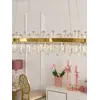 Złoty detal Żyrandola BULGARI L 100cm, doskonały wybór dla miłośników elegancji. Aranżacja nowoczesnego wnętrza od Primavera Home.