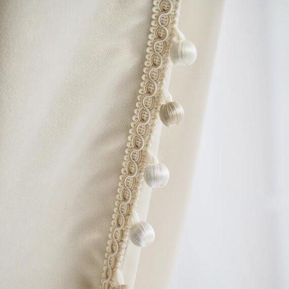 Exclusive curtain richly decorated with haberdashery