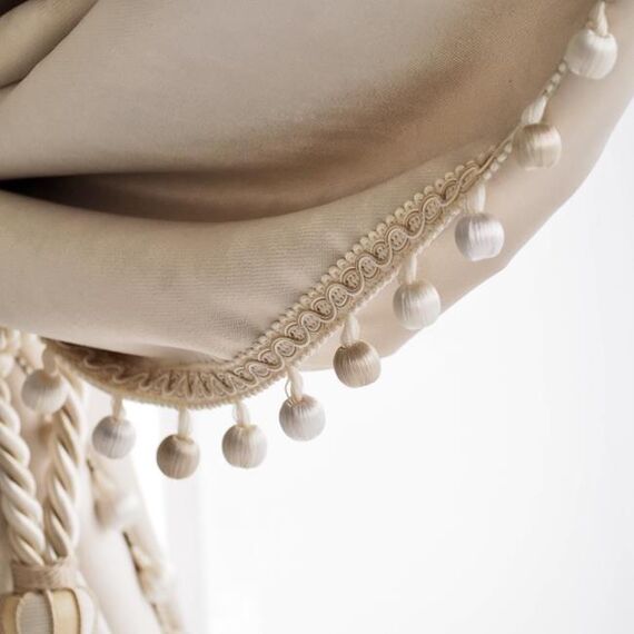 Exclusive curtain richly decorated with haberdashery