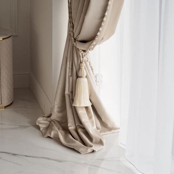 Exclusive curtain richly decorated with haberdashery