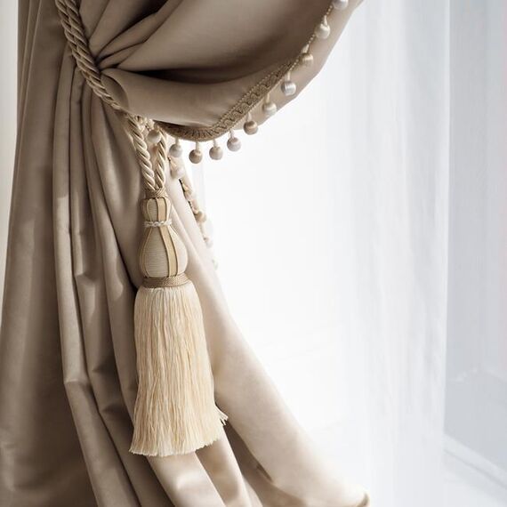 Exclusive curtain richly decorated with haberdashery