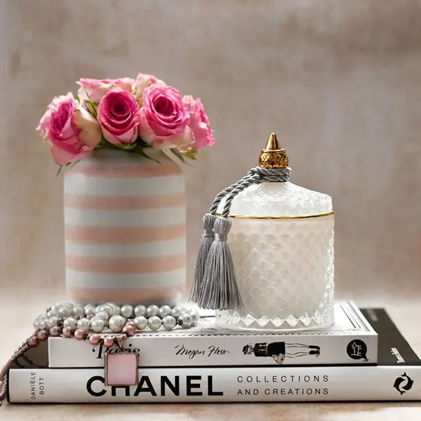 Decorative scented candle in a white and gold crystal glass container