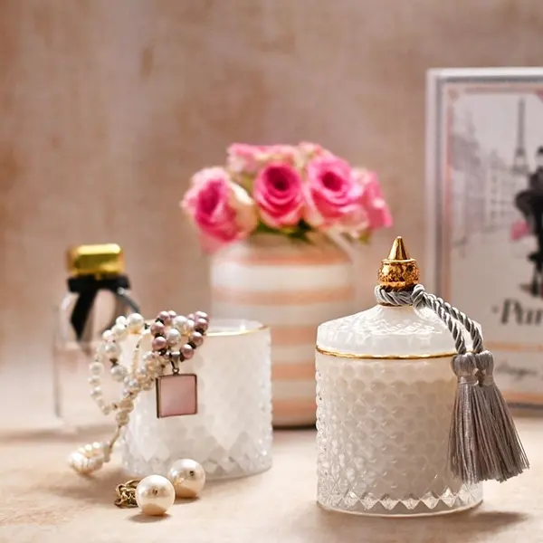 Decorative scented candle in a white and gold crystal glass container