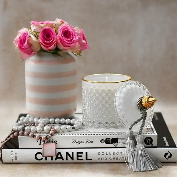 Decorative scented candle in a white and gold crystal glass container