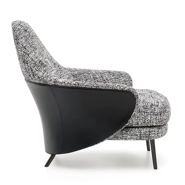 Modern, upholstered designer armchair on black legs with a LINEA footstool