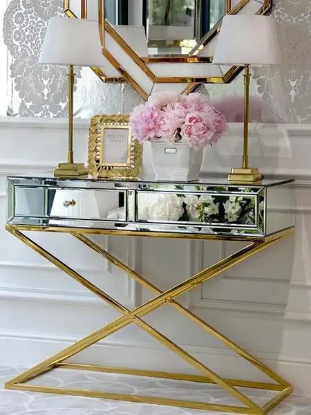 Konsola lustrzana CHICAGO GOLD glamour stalowa złota ustawiona przy ścianie, tworząca elegancki akcent. Ekspozycja w salonie Primavera Home.