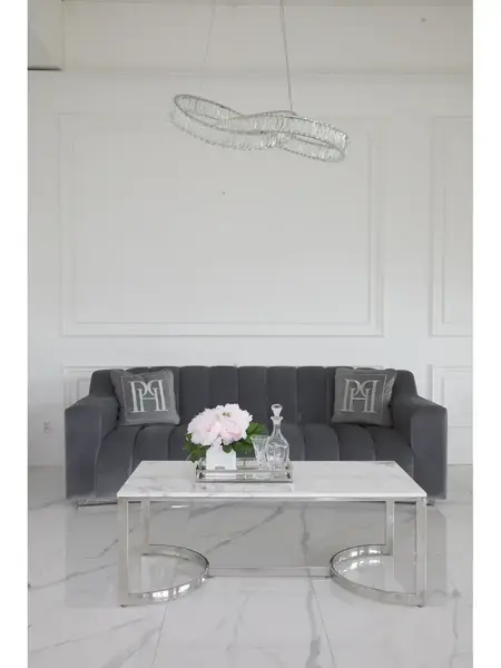 Widok z boku stolika kawowego Lola srebrnego z białym blatem w eleganckim wnętrzu. Meble na zamówienie od PRIMAVERA HOME.