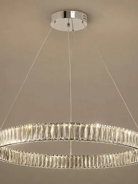 Z bliska pokazany Żyrandol Kryształowy Crystal Srebrny Glamour w przyciemnionej atmosferze. Aranżacja nowoczesnego wnętrza od Primavera Home.