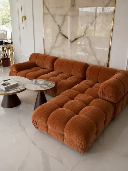 Widok poziomy na designerski narożnik modułowy boucle NICEA z innymi elementami wnętrza. Meble na zamówienie od Primavera Home.