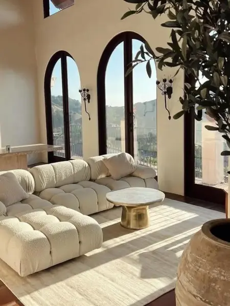 Aranżacja z innymi meblami w otoczeniu designerskiego narożnika modułowego boucle NICEA. Meble na zamówienie od Primavera Home.