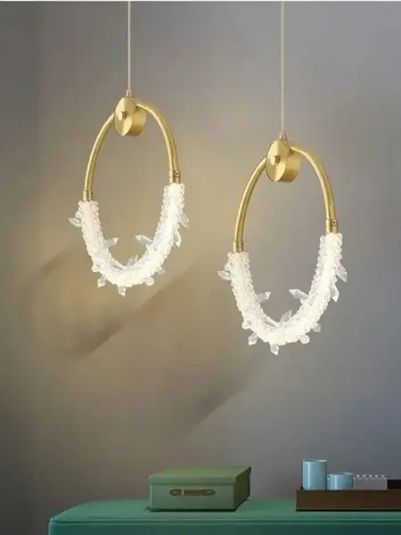 Żyrandol Kryształowy Złoty w jasnym wnętrzu, dodający przestrzeni elegancji od Primavera Home.