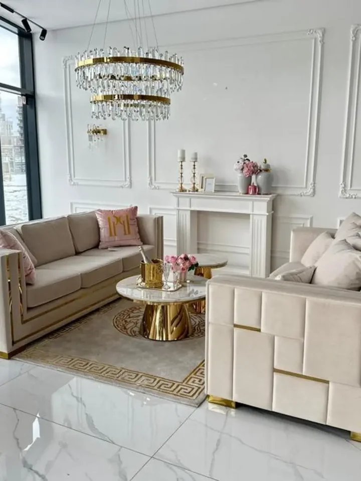 Stolik kawowy BOND glamour, złoty z białym marmurowym blatem w jasnym pomieszczeniu. Ekspozycja w salonie od Primavera Home.
