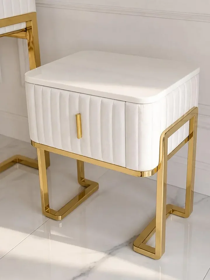 Szafka nocna glamour nowoczesna, beżowa, złota, stolik boczny z szufladą AMORE w klimatycznej aranżacji sypialni. Ekspozycja w salonie od Primavera Home.