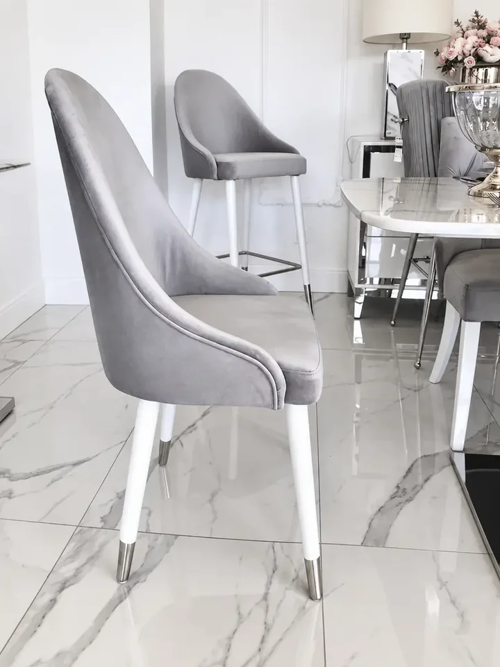 Zbliżenie na detal wykończenia krzesła srebrnego szarego tapicerowanego glamour od Primavera Home.