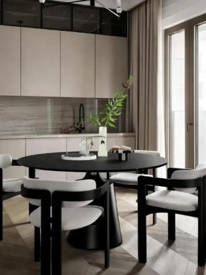 Okrągły Stół do Jadalni Oslo Spiekany kamień czarny Carrara i Stal Premium umieszczony w stylizowanym otoczeniu. Aranżacja nowoczesnego wnętrza od Primavera Home.