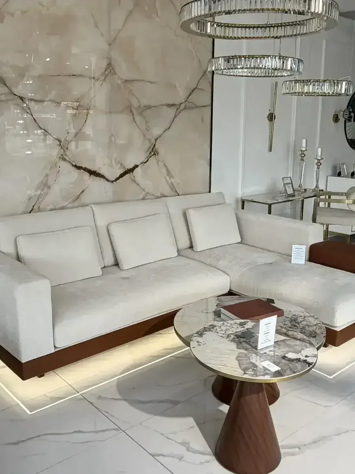 Sofa narożna z półką w cichym kącie, tworząca intymną przestrzeń od Primavera Home.