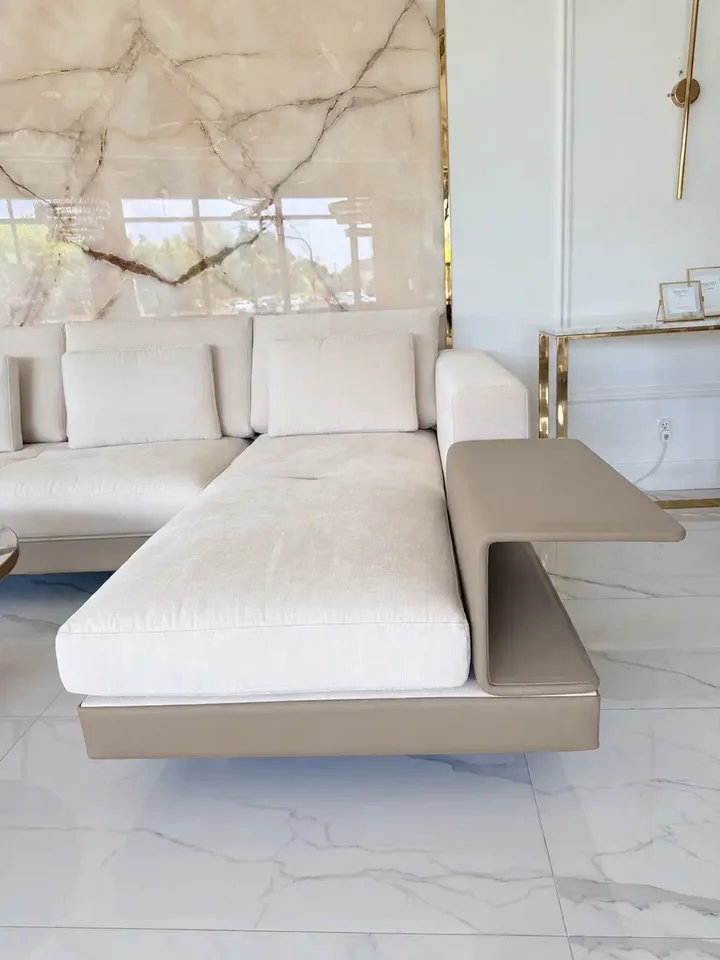 Szczegółowy widok na nogi sofy narożnej z półką, podkreślający ich design i elegancję od Primavera Home.