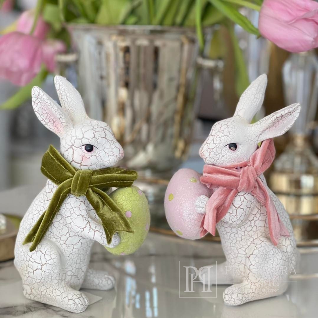 White ceramic Easter rabbit with a pink egg, with a velor bow