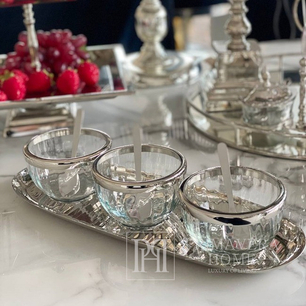 Three silver bowls on a tray with spoons for snacks, table set