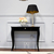 A black wooden console in a glamor style with a high gloss ELEGANT