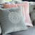 Decorative gray velvet pillow with Medusa logo