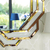 Abgerundeter geometrischer Spiegel in einem dekorativen Goldrahmen DUNE GOLD