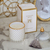 Decorative scented candle in a white and gold crystal glass container