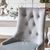 Sidabriškai pilka minkšta kėdė ant MADAME išlenktų plieninių kojų 