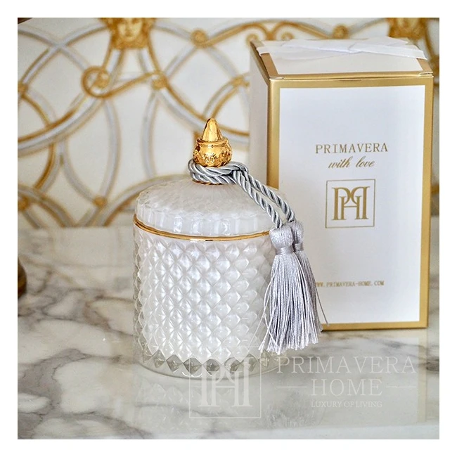 Decorative scented candle in a white and gold crystal glass container